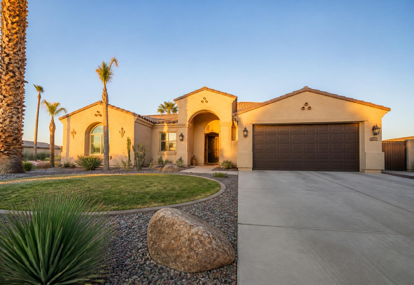Southwestern style home with palm trees at golden hour in Yuma, Arizona